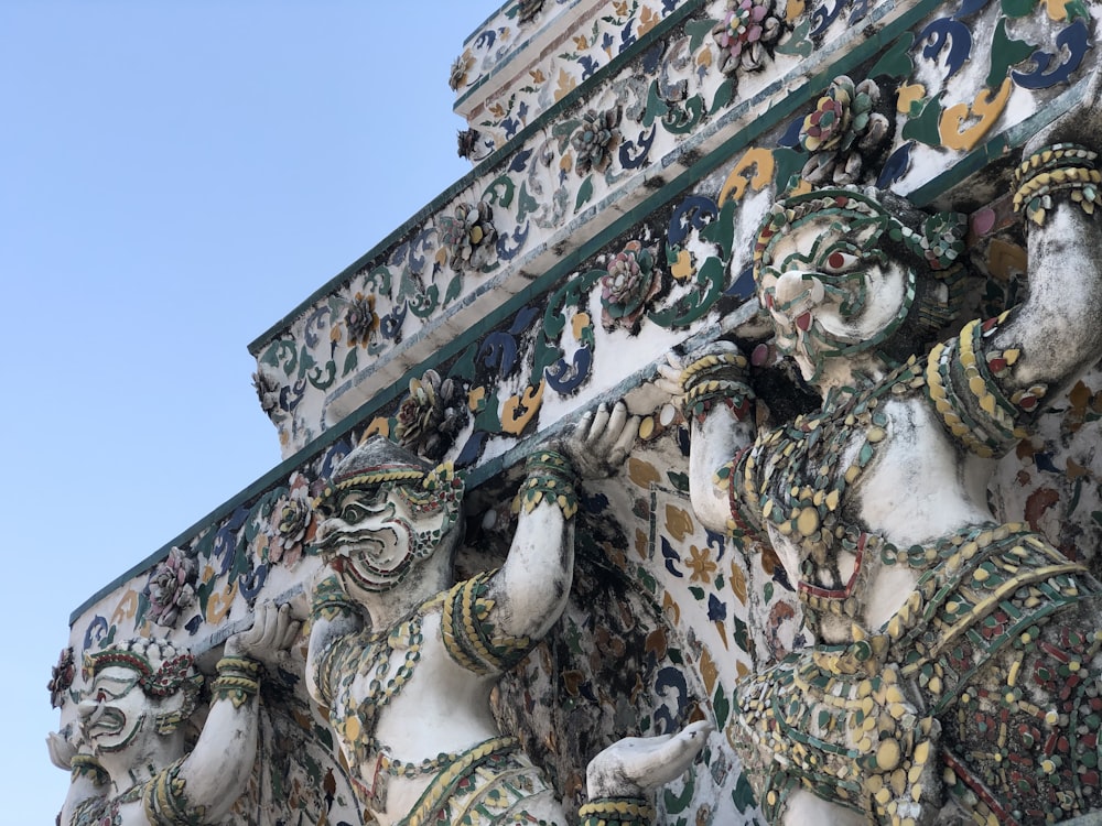 a close up of a building with statues on it