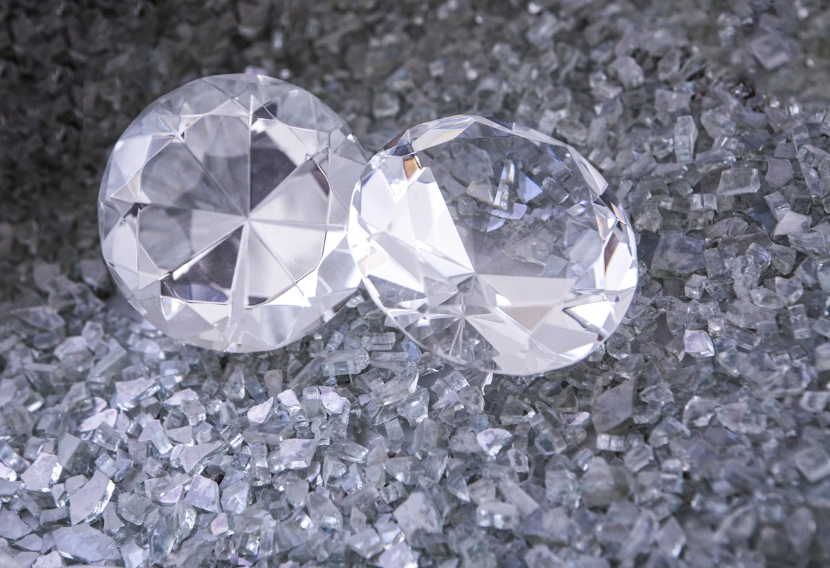 Two large faceted diamonds resting on crushed crystal