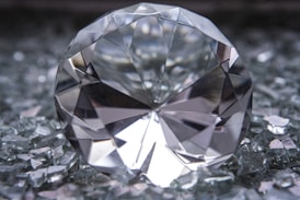 a diamond sitting on top of a pile of glass