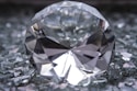 a diamond sitting on top of a pile of glass