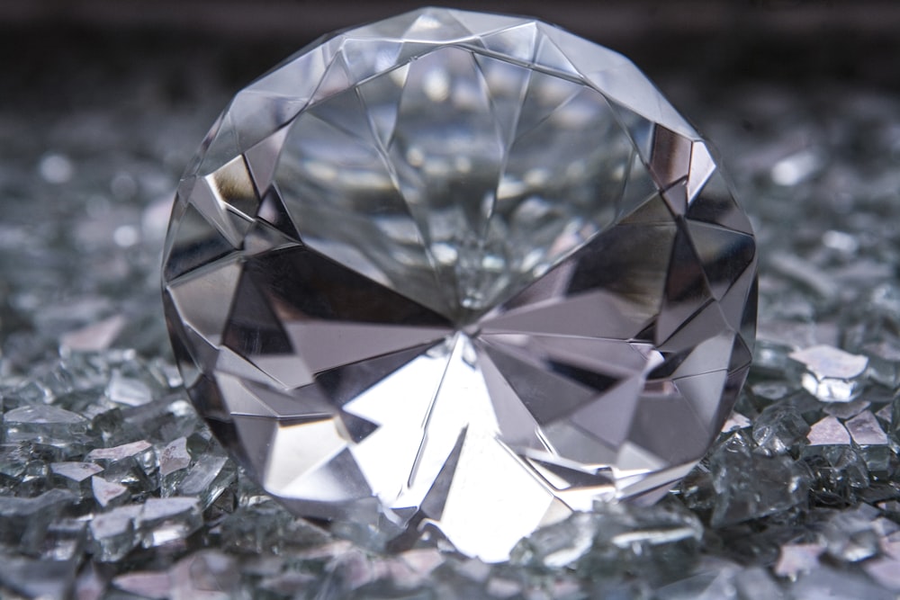 a diamond sitting on top of a pile of glass