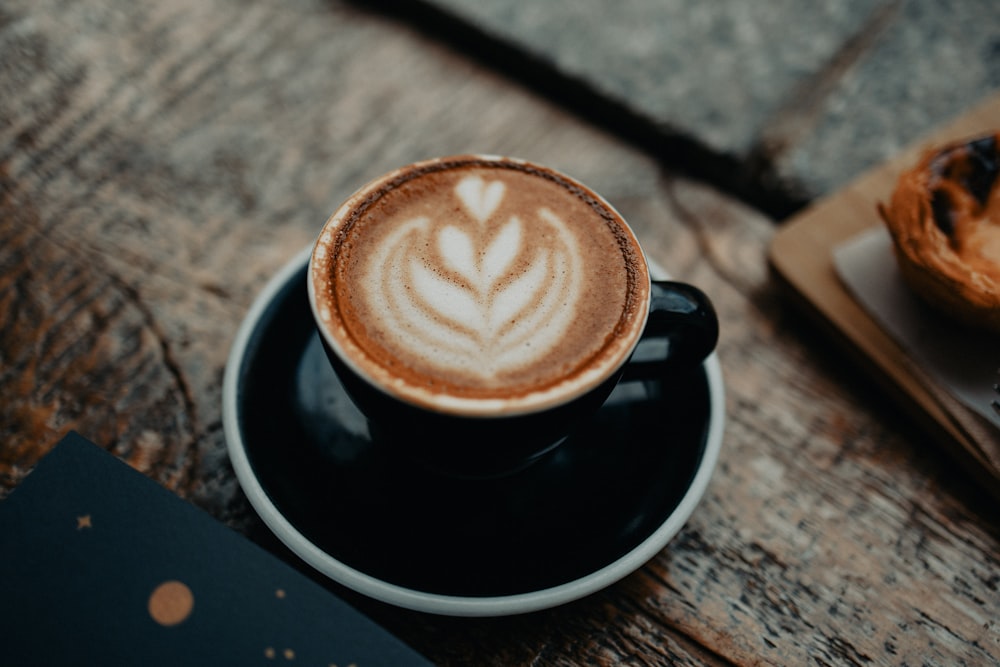 a cappuccino on a saucer on a wooden table