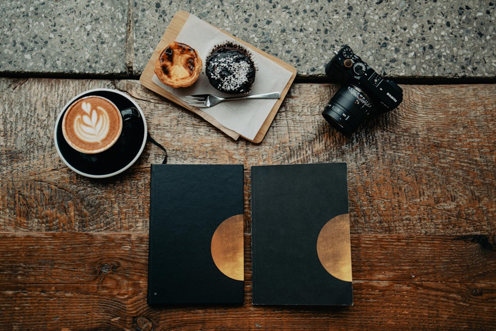 a couple of doughnuts sitting on top of a wooden table