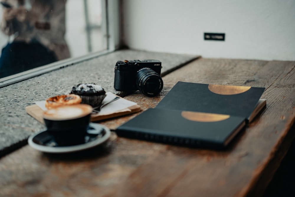 a table with a cup of coffee and a camera