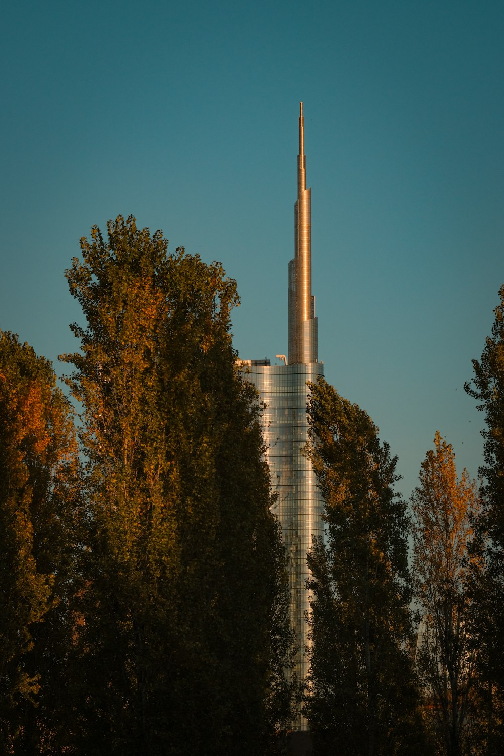 a tall building surrounded by lots of trees