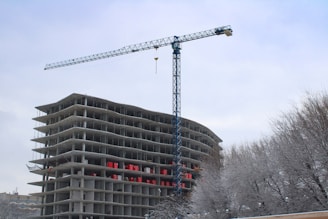 a crane is on top of a building under construction