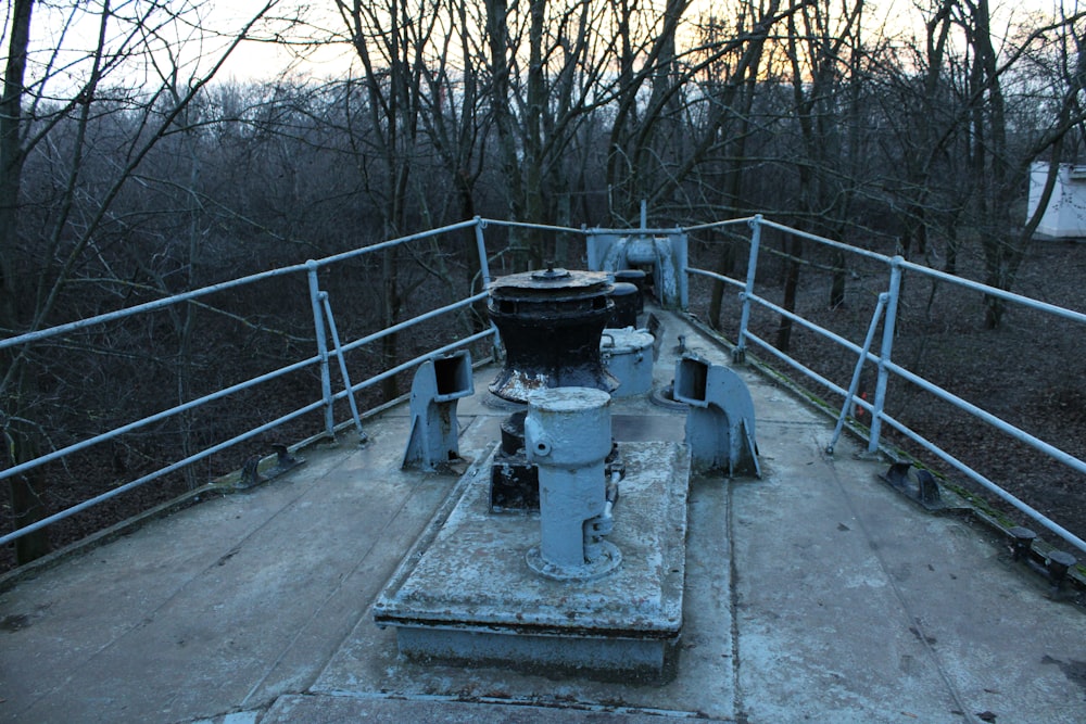 a metal railing with a bucket on top of it