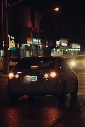 Evening driving session with city lights glowing through the car windows.