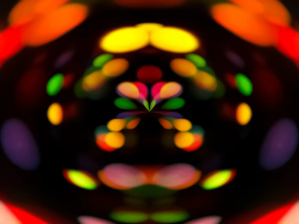 A mesmerizing display of blurred, colorful lights forming patterns against a dark background, creating an abstract visual effect.