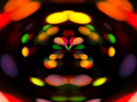 A mesmerizing display of blurred, colorful lights forming patterns against a dark background, creating an abstract visual effect.