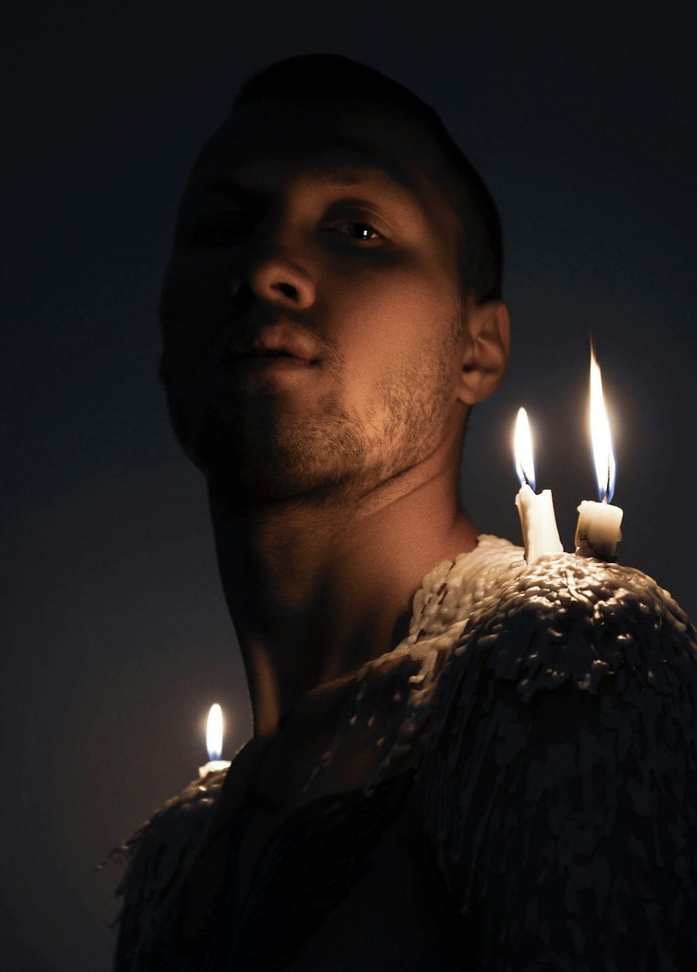 a man holding a lit candle in his hand