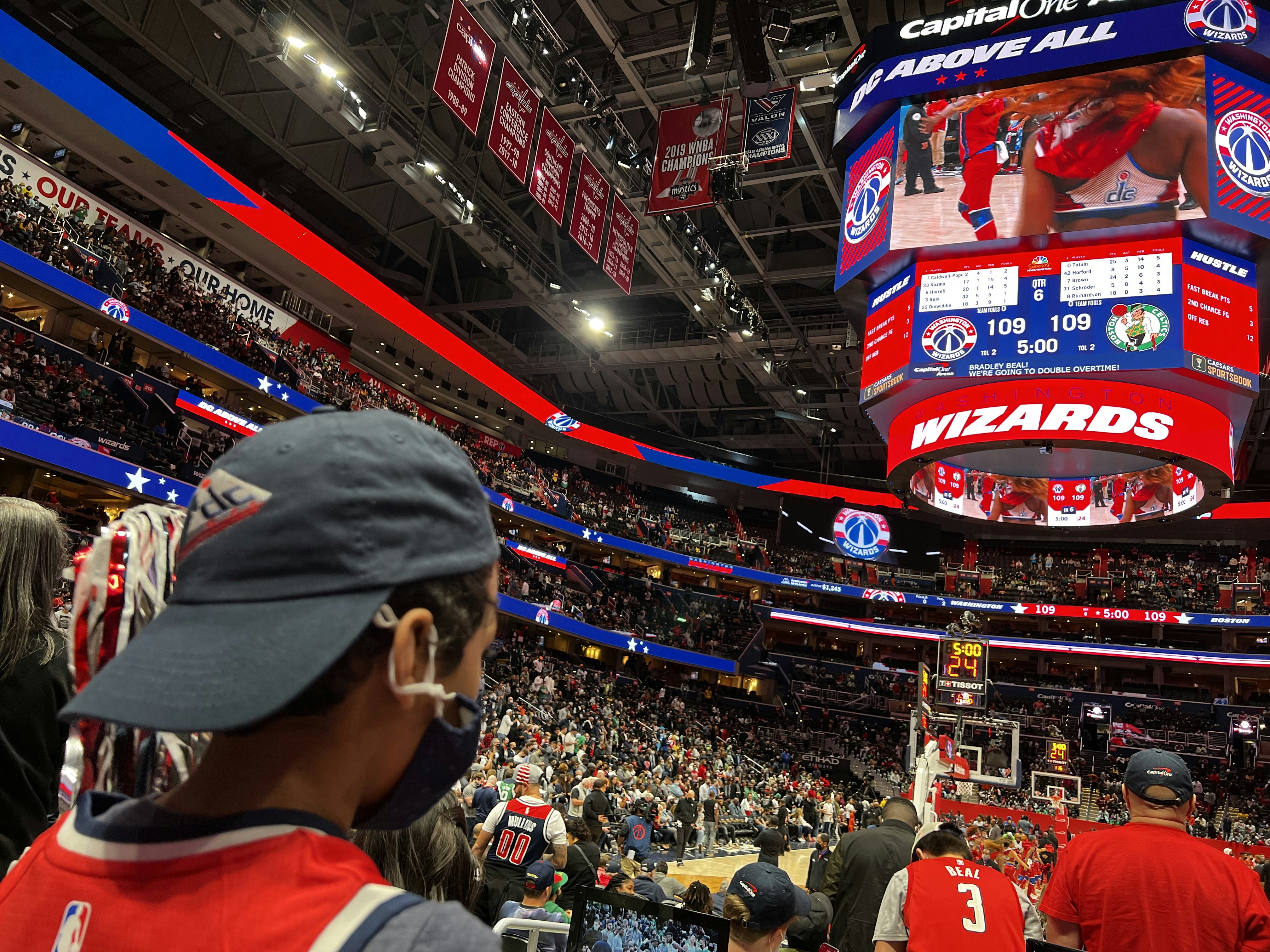 a crowd of people standing around a basketball court (Photo by The-Lore on Unsplash)