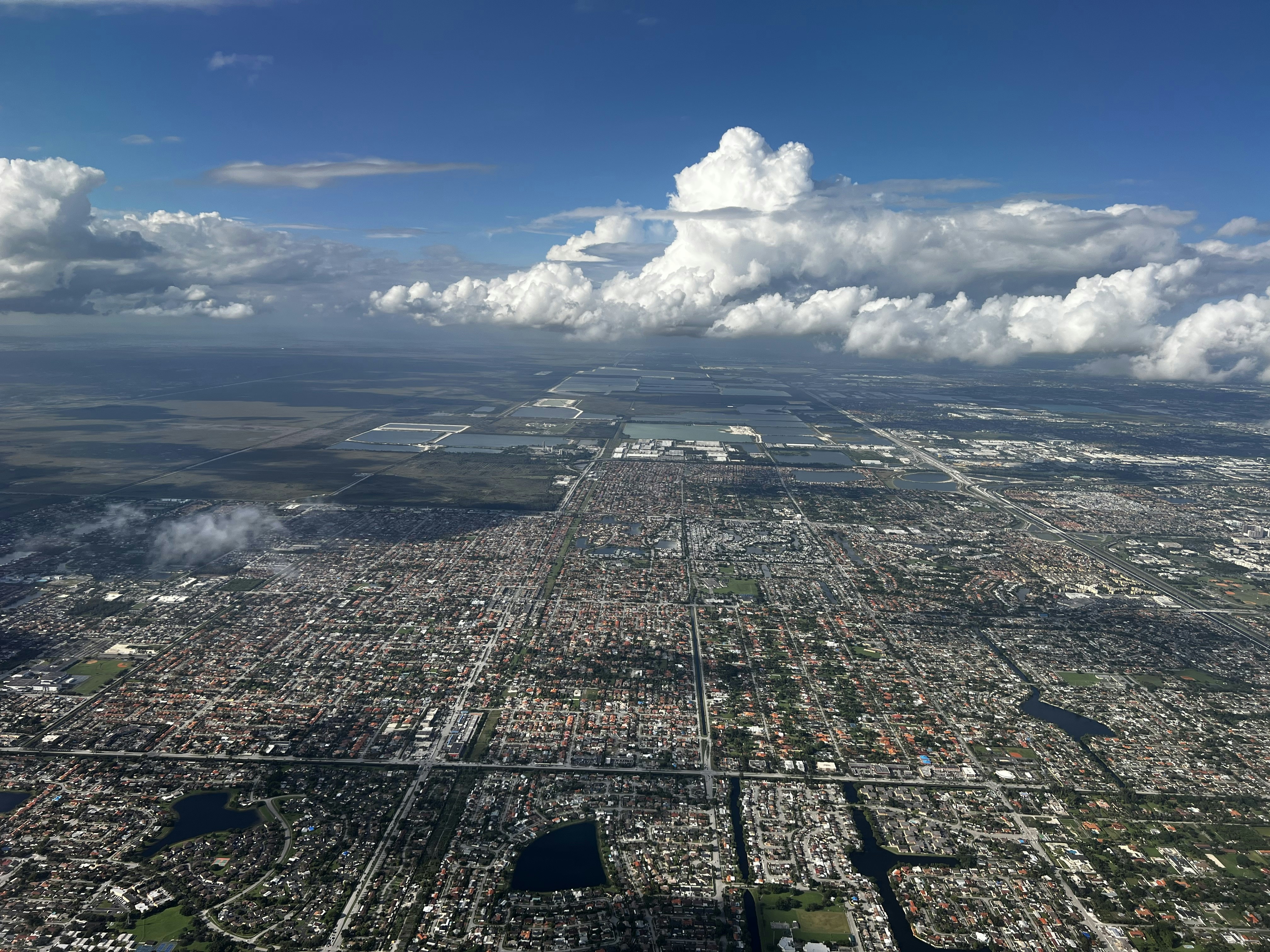 An aerial view of a city with clouds in the sky photo – Free Grey Image ...