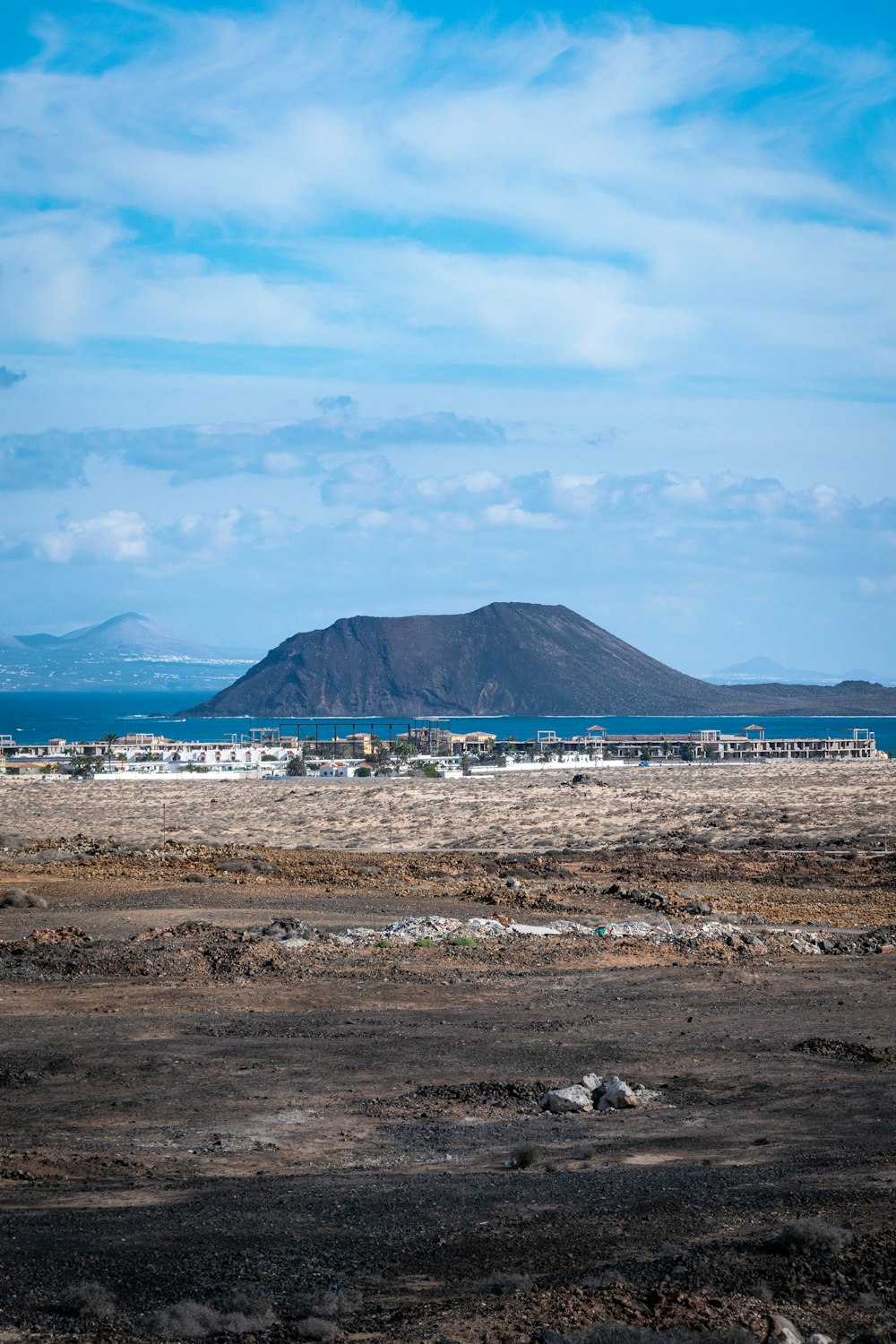 a large field with a mountain in the background