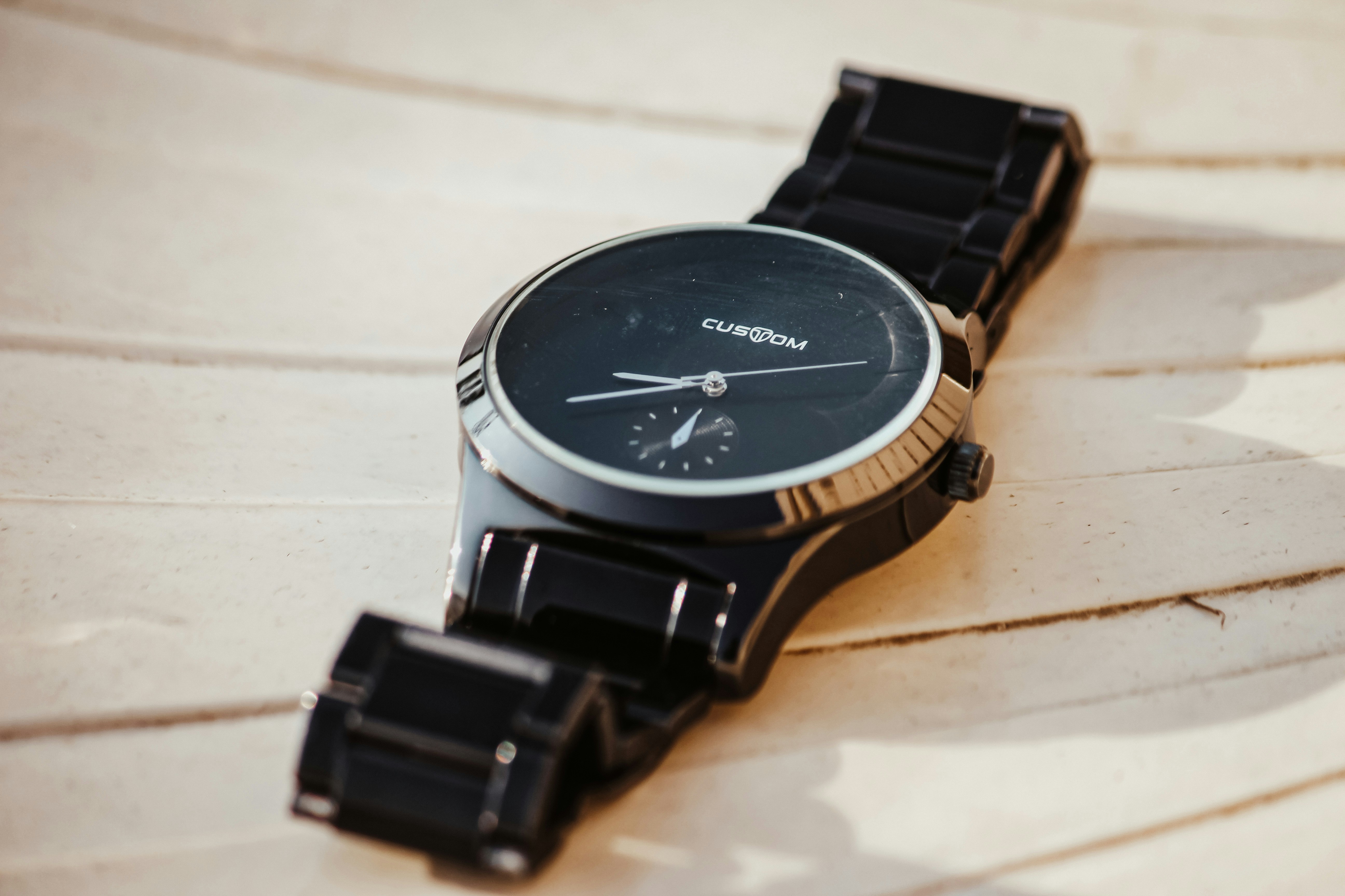 a watch sitting on top of a wooden table