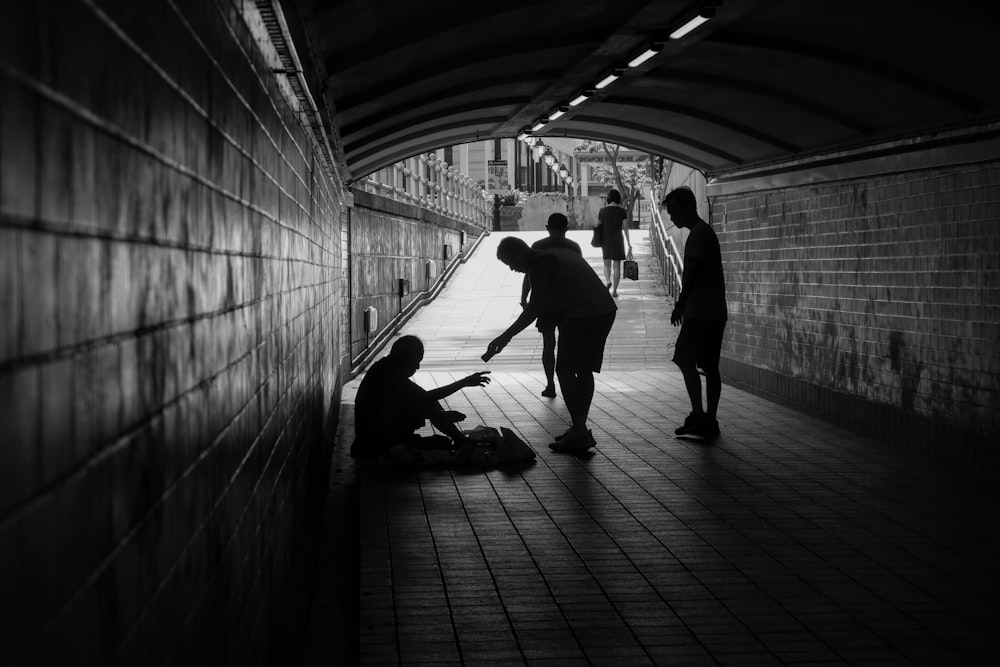 a group of people standing in a tunnel