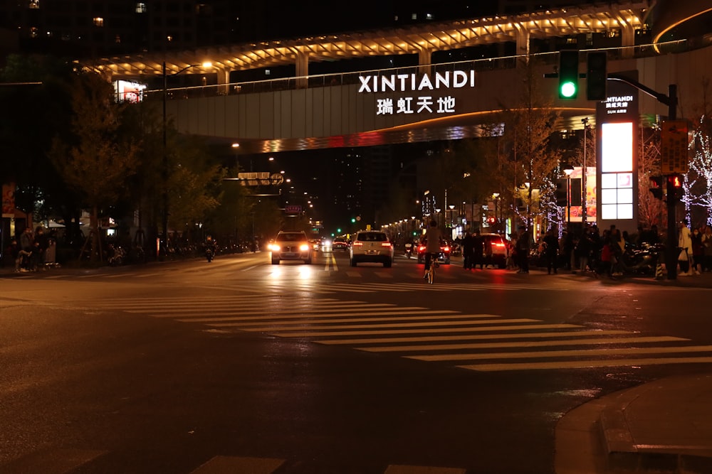 a city street at night with a green traffic light