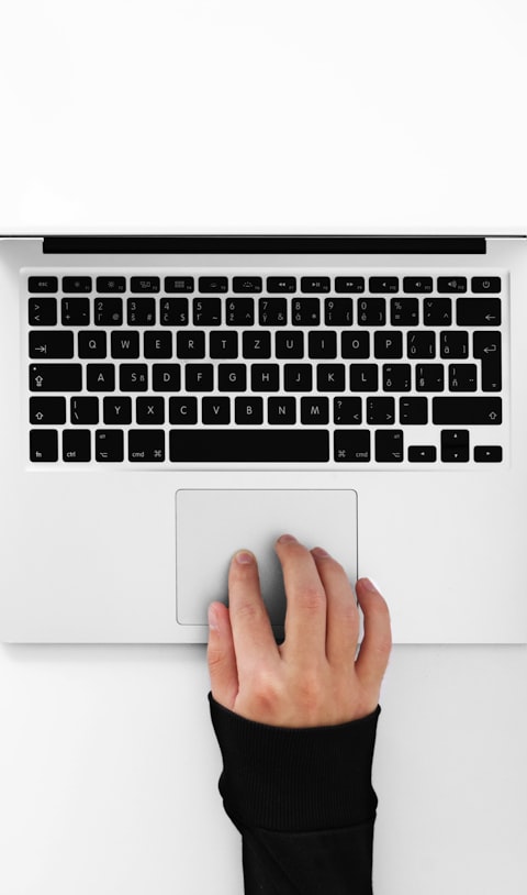 Typing on a laptop, top-down — photo: Adrian Regeci on Unsplash