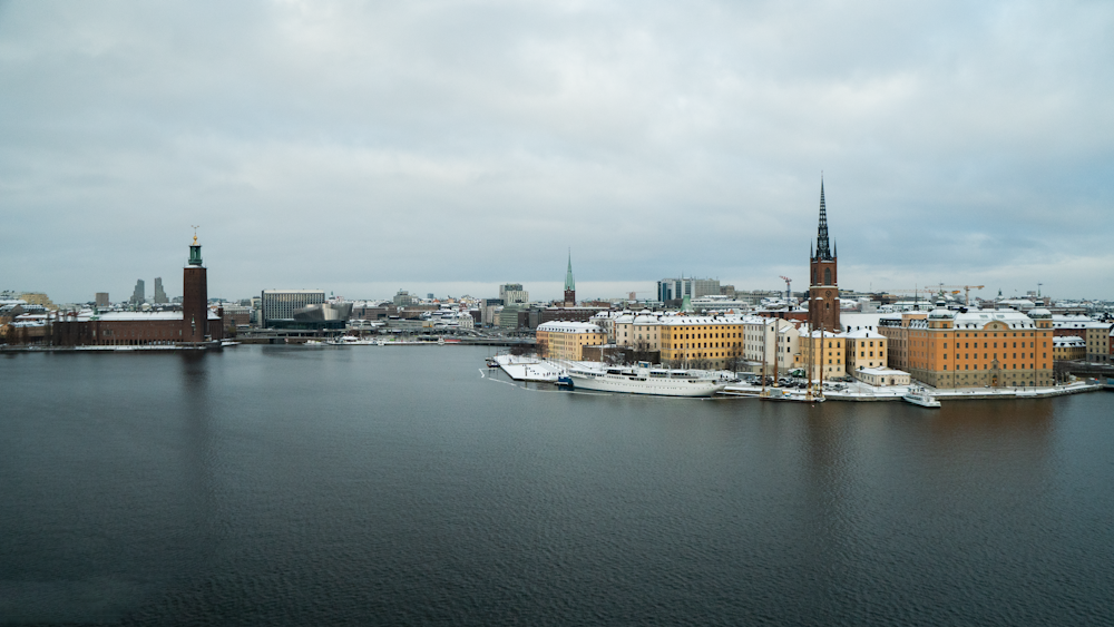 a large body of water with a city in the background