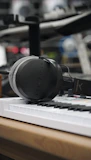 A producer working on a beat with headphones in an olive-toned studio