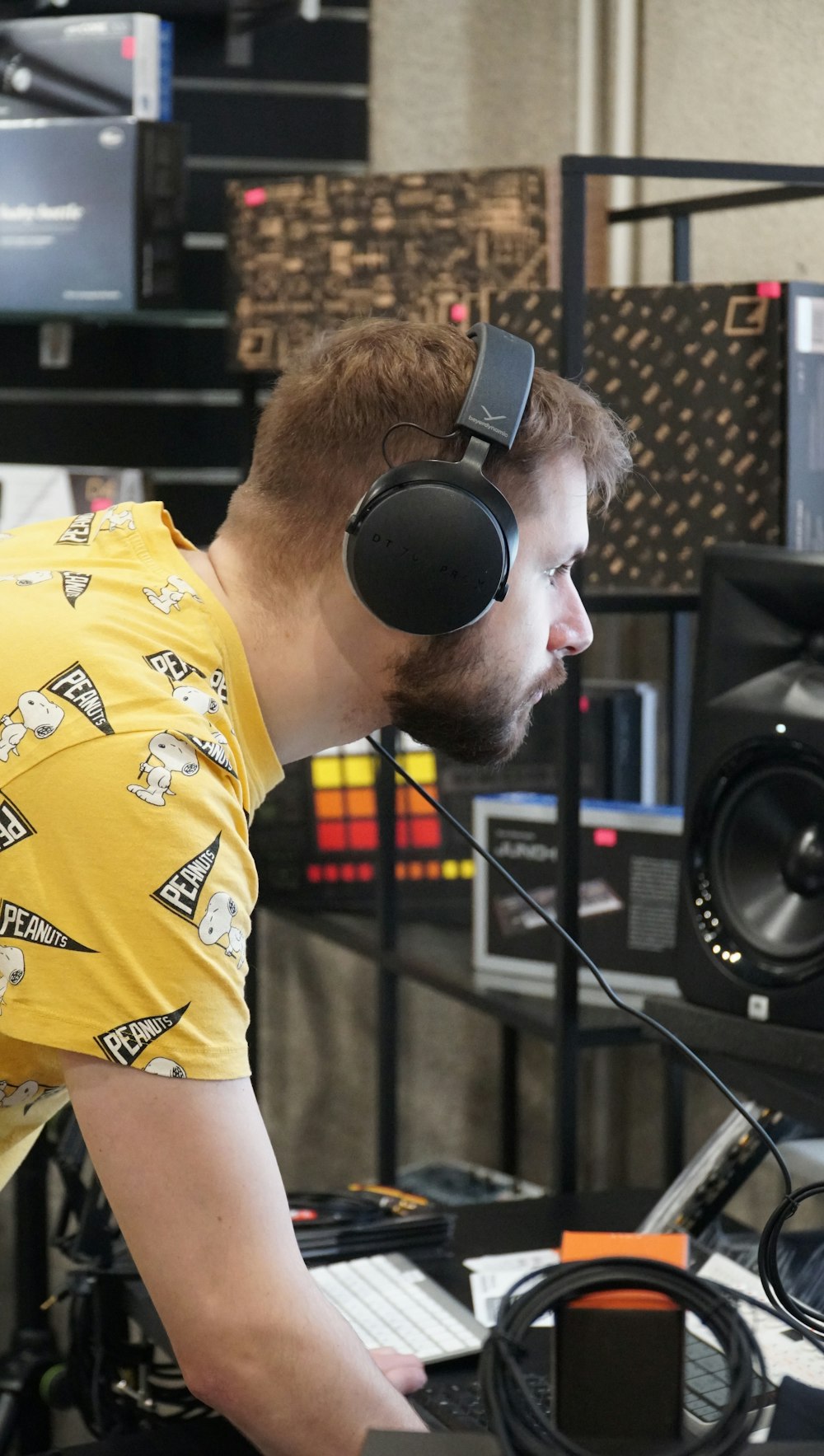 a man wearing headphones and a yellow shirt