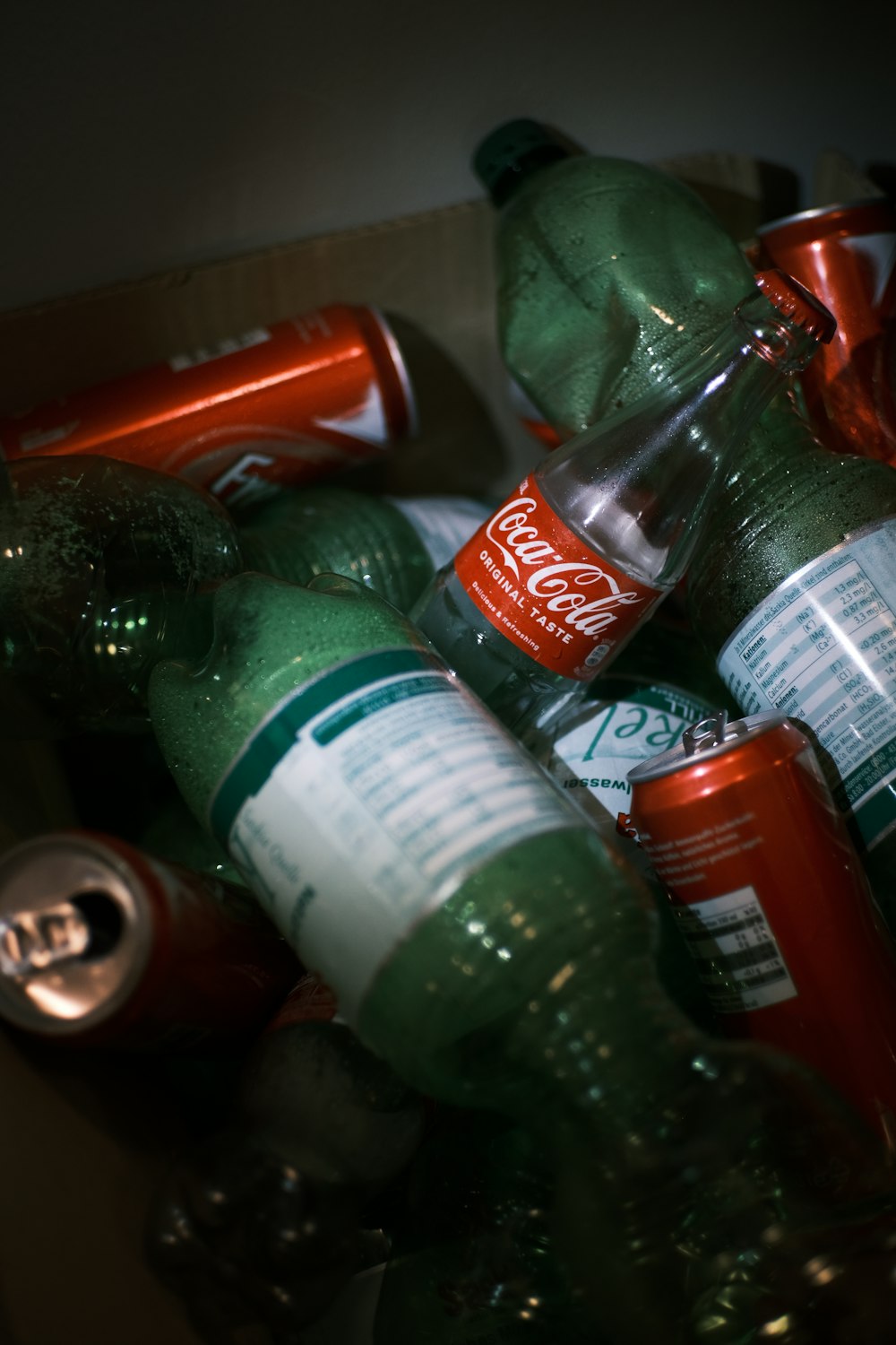 a pile of coca cola bottles sitting on top of a table
