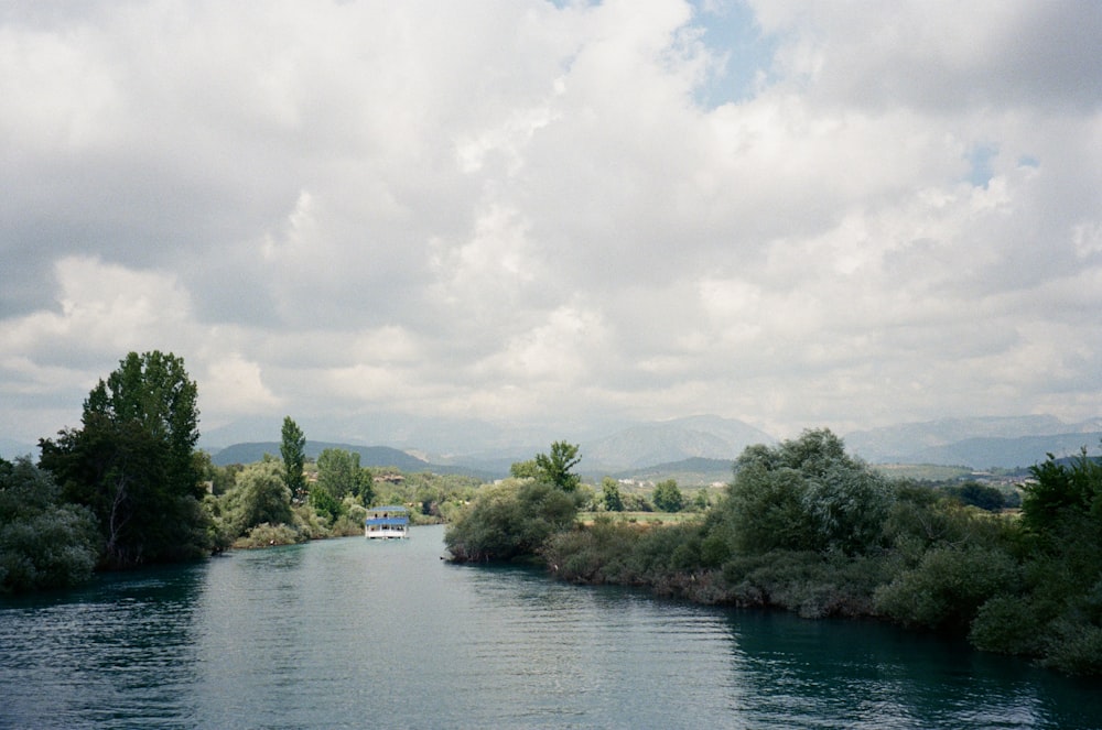 a body of water surrounded by trees and hills