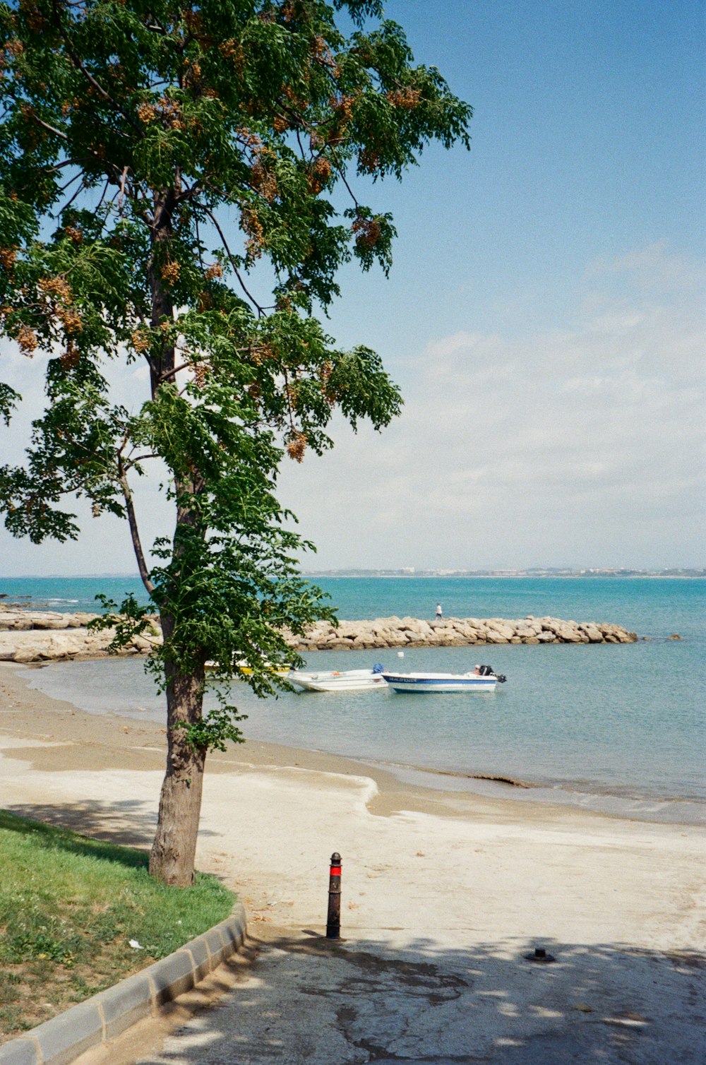 a boat is out on the water near a beach