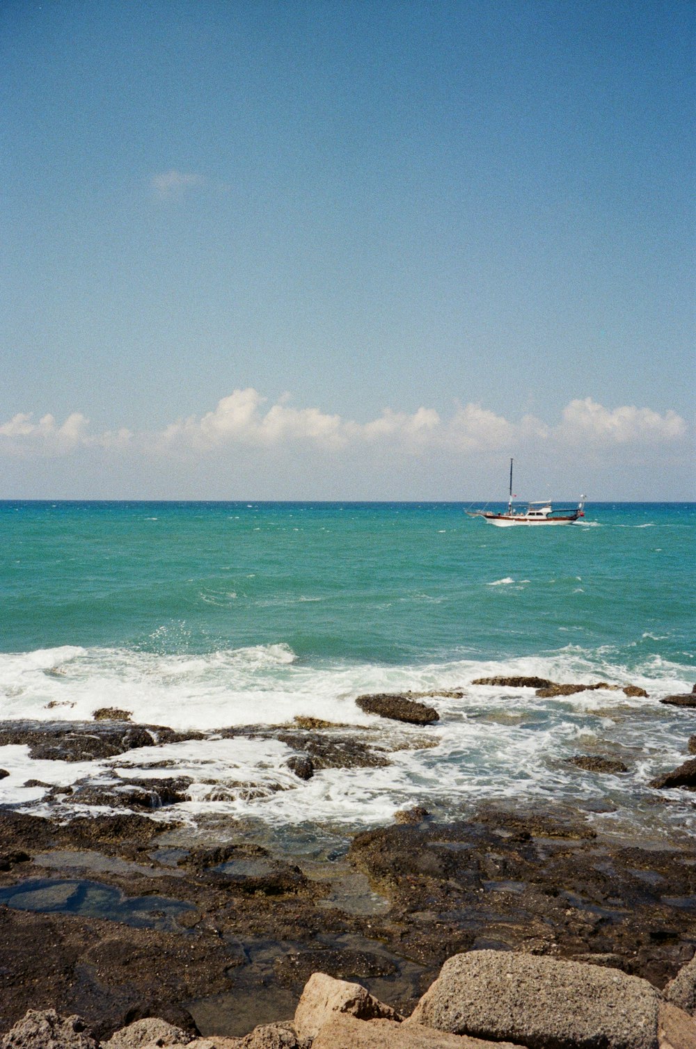 a boat is out in the ocean on a sunny day