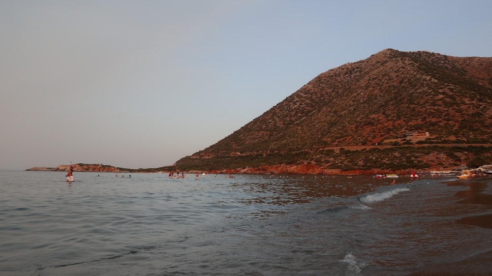 a body of water with a mountain in the background