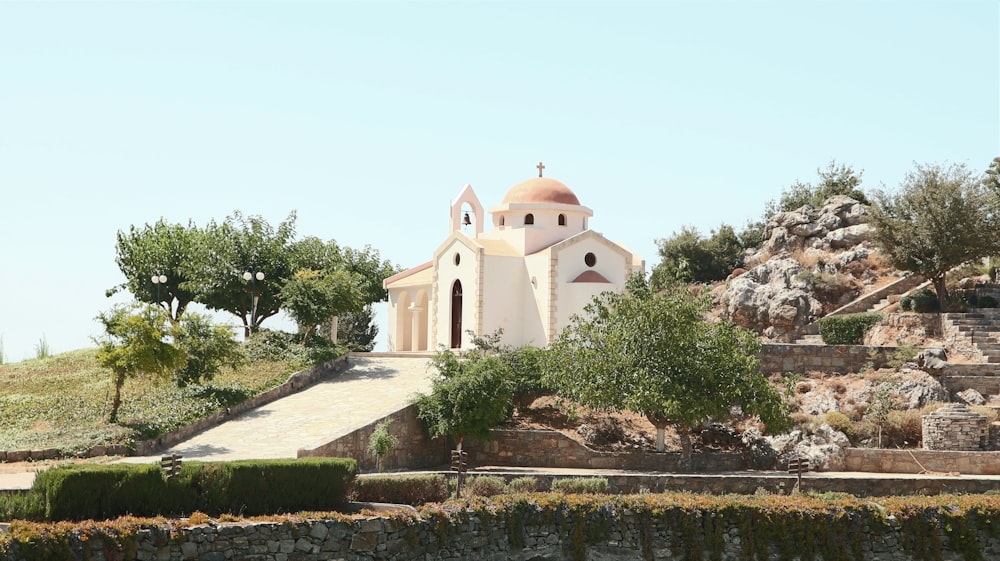 a church on a hill with a stone pathway leading up to it