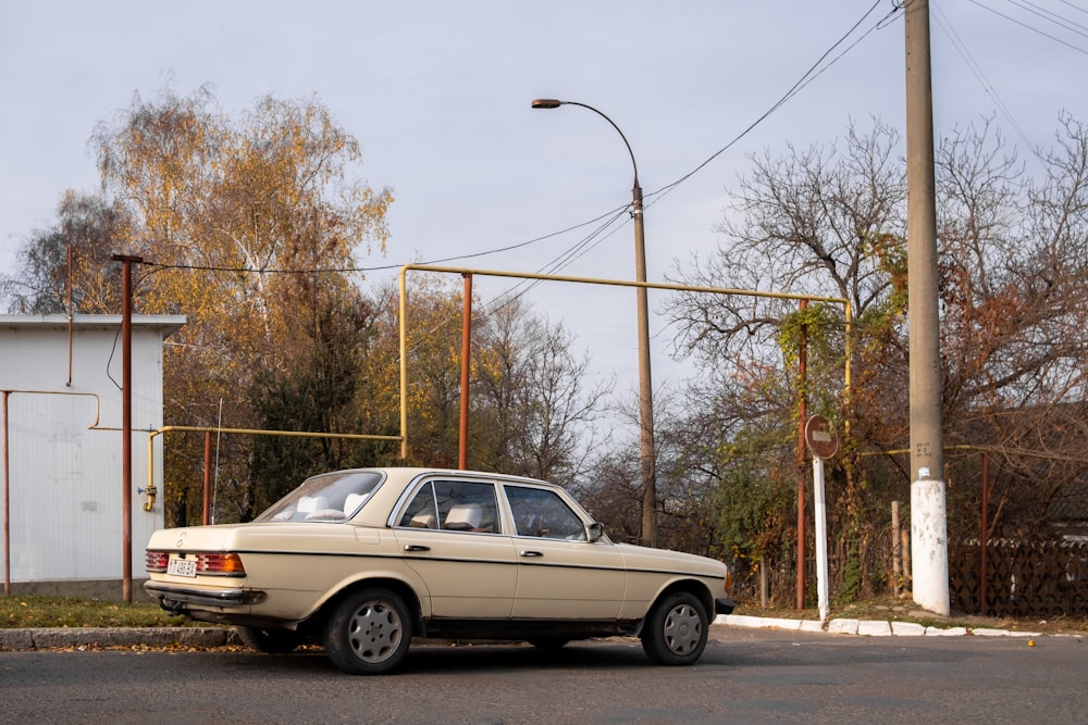 a beige car parked on the side of the road