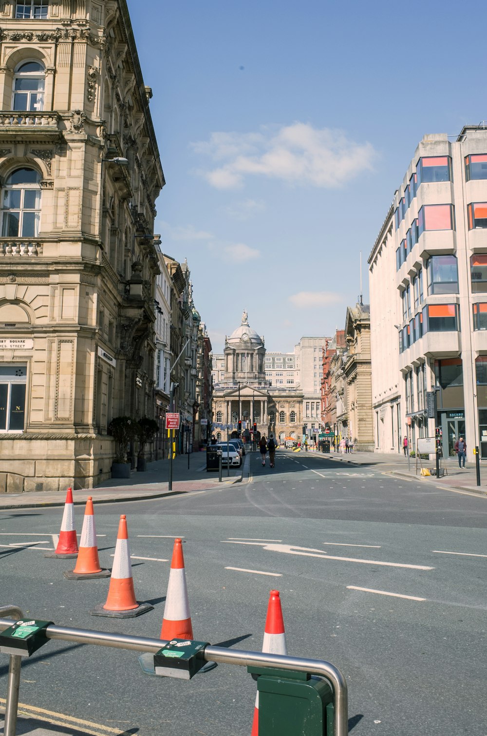 a city street with traffic cones on the side of it