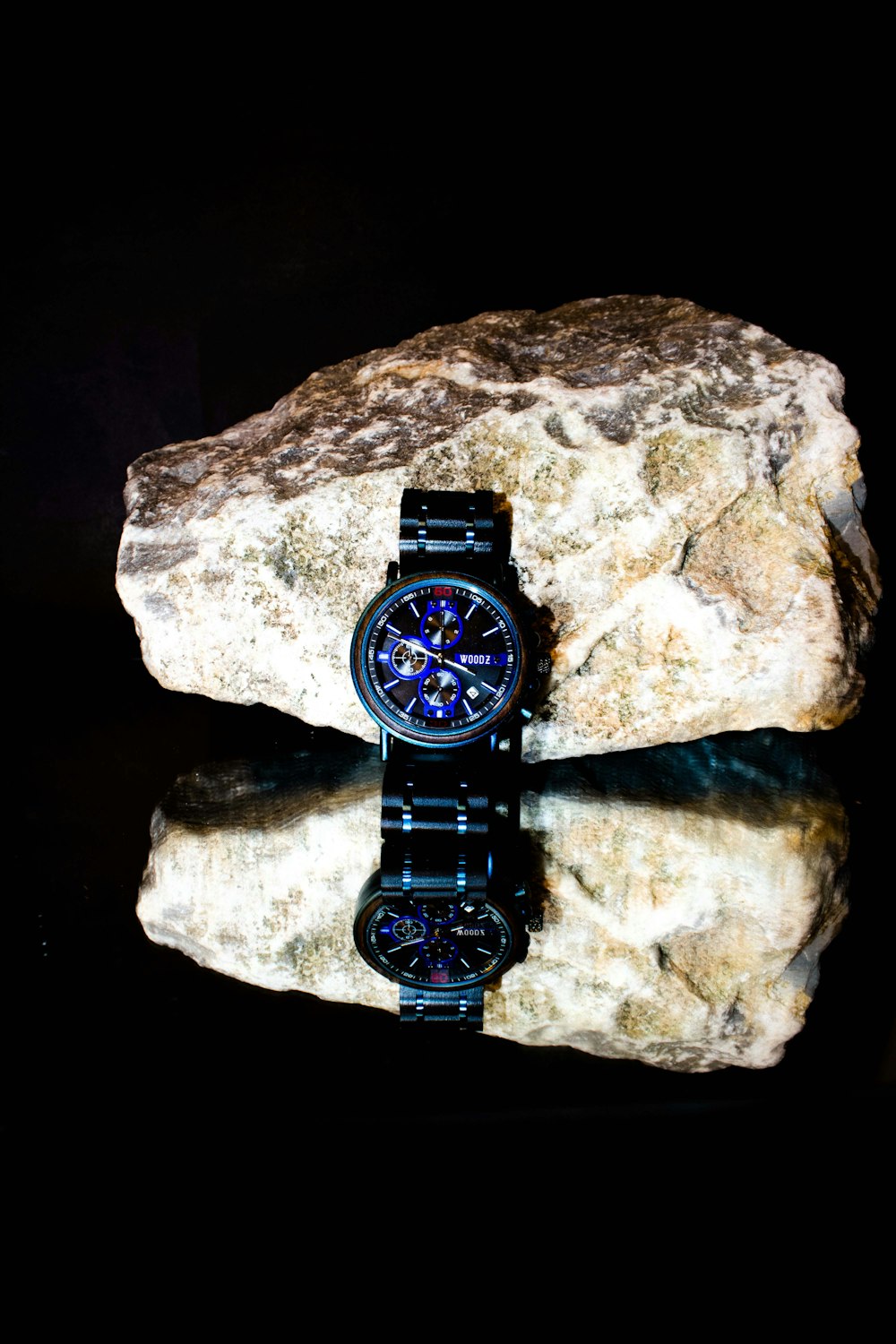 a watch sitting on top of a rock