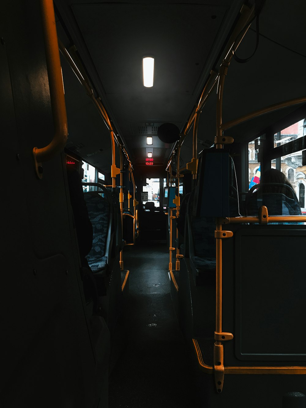 a dimly lit bus with its lights on