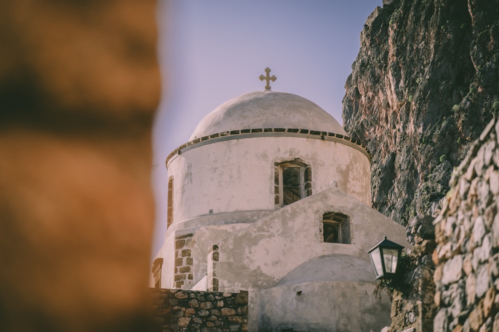 a white building with a cross on top of it