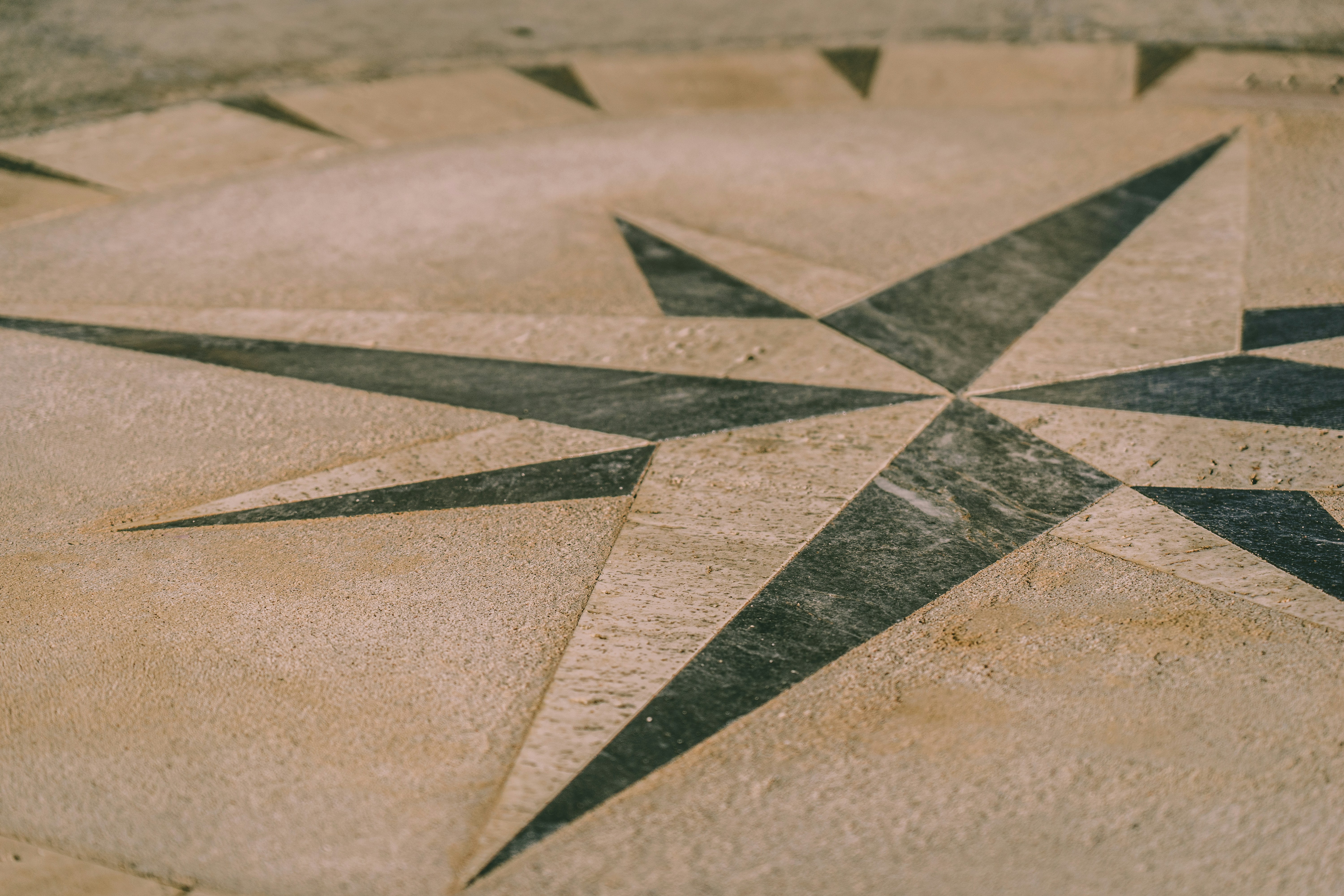 a black and white picture of a star on the ground