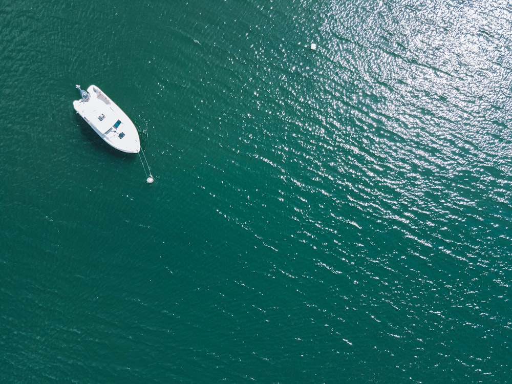 a small boat floating on top of a large body of water