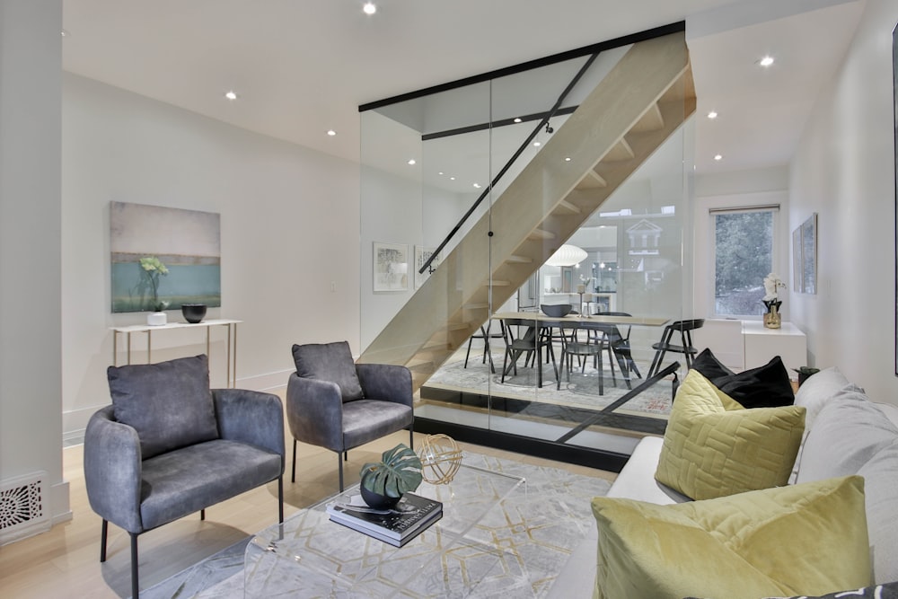 a living room filled with furniture and a staircase