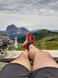 a person sitting on a bench with their feet up