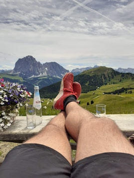 a person sitting on a bench with their feet up