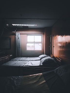 A friendly nurse preparing an IV infusion in a cozy clinic room with soft lighting.