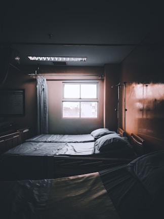 A peaceful patient room with advanced monitoring equipment and natural light streaming in.