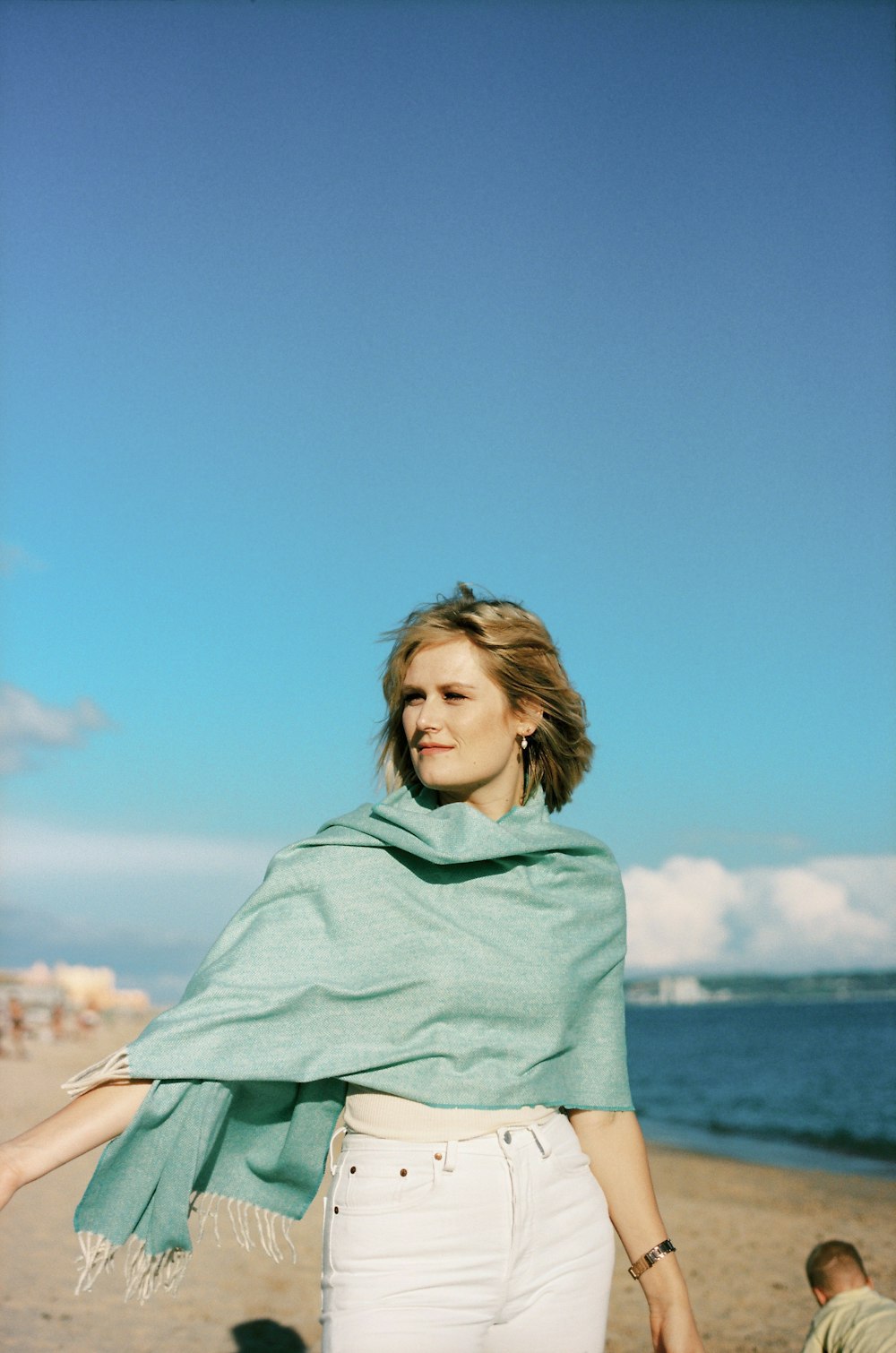 a woman standing on top of a sandy beach