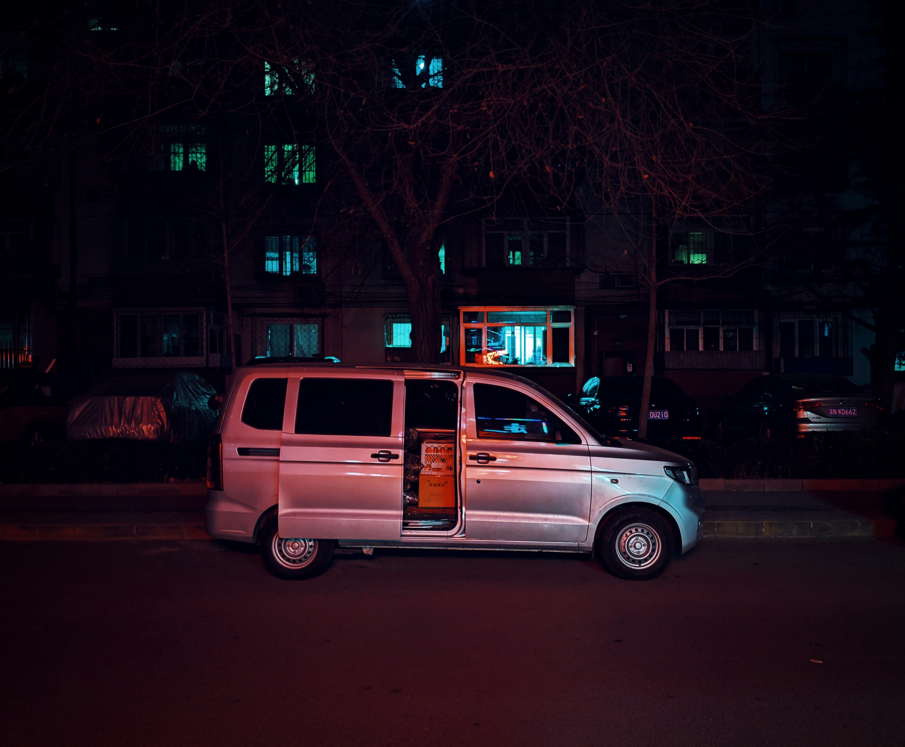 a van parked on the side of the road at night