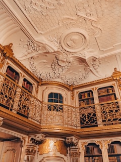 Delicate gold divider detail on parchment-textured walls inside a quiet study room.