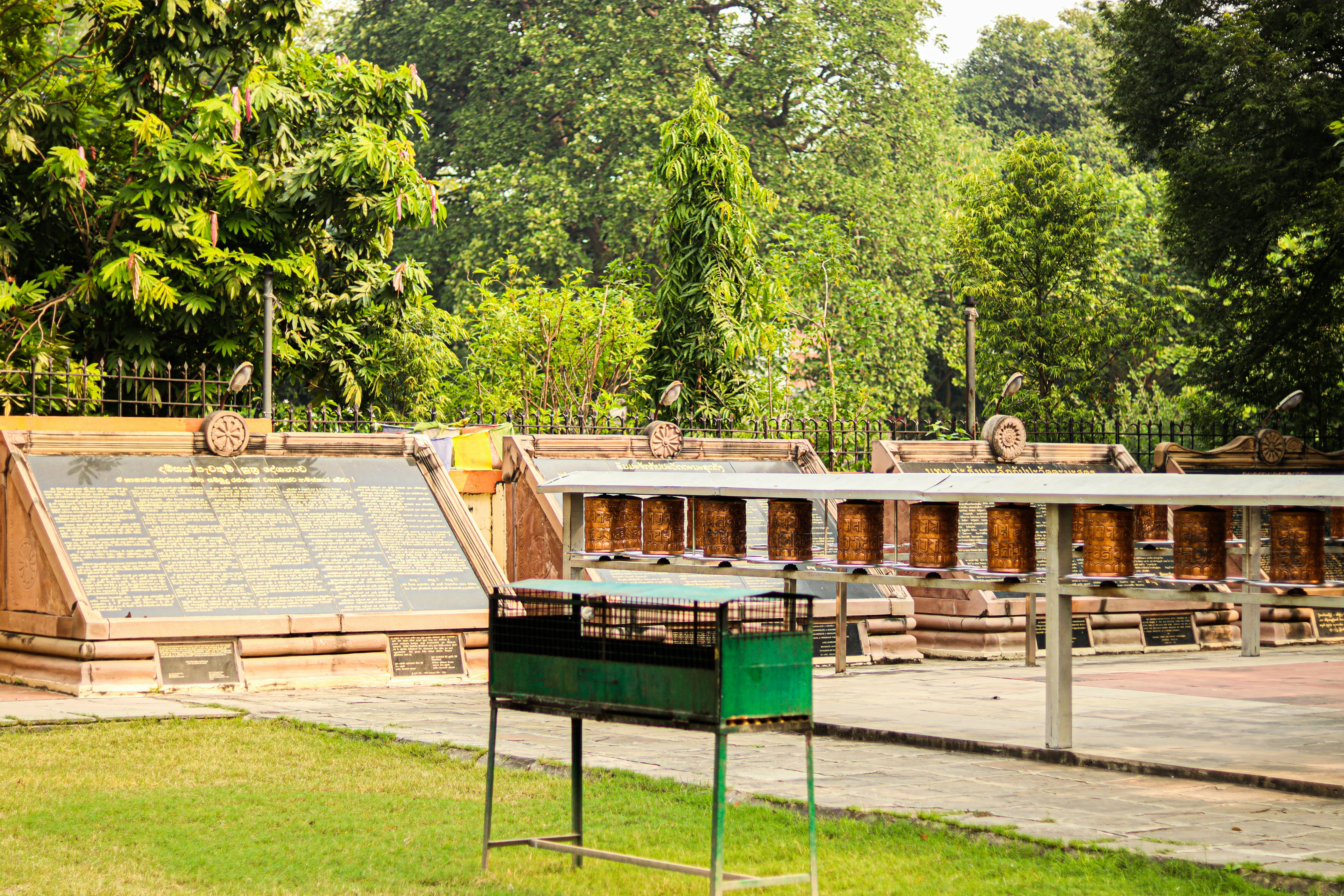 Wooden shelters with a barbecue on grass