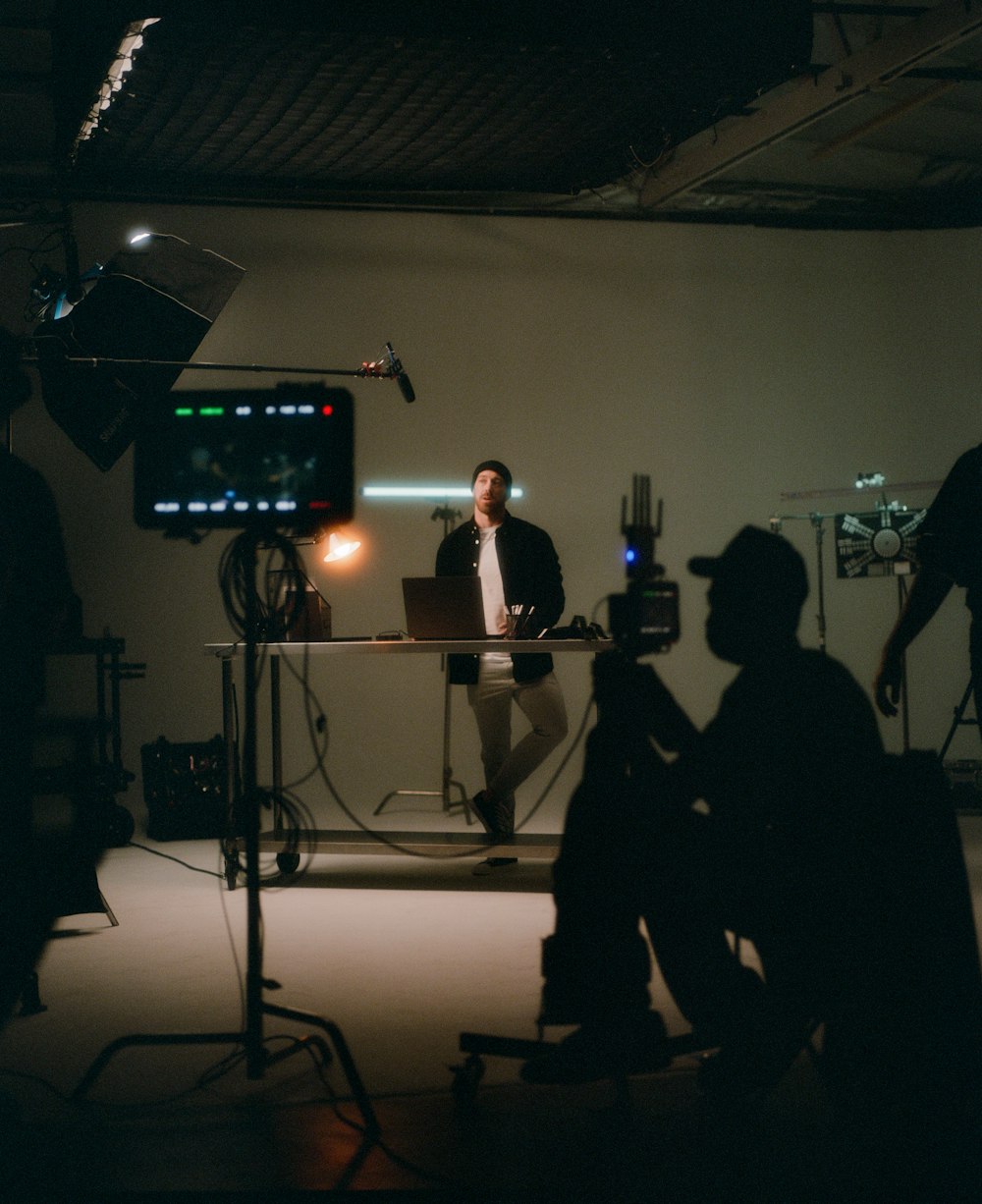 a group of people sitting around a camera