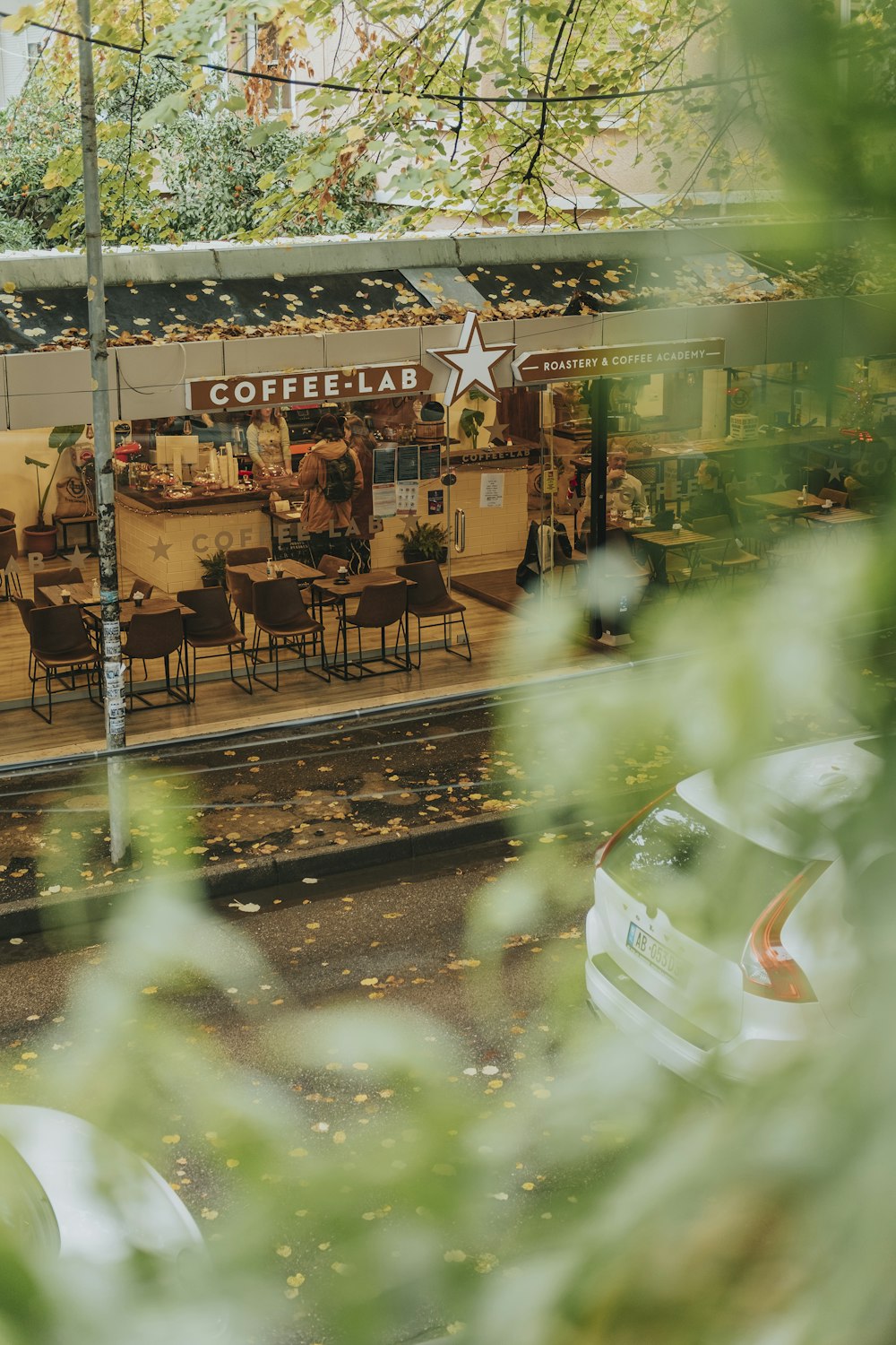 a restaurant with tables and chairs on a rainy day