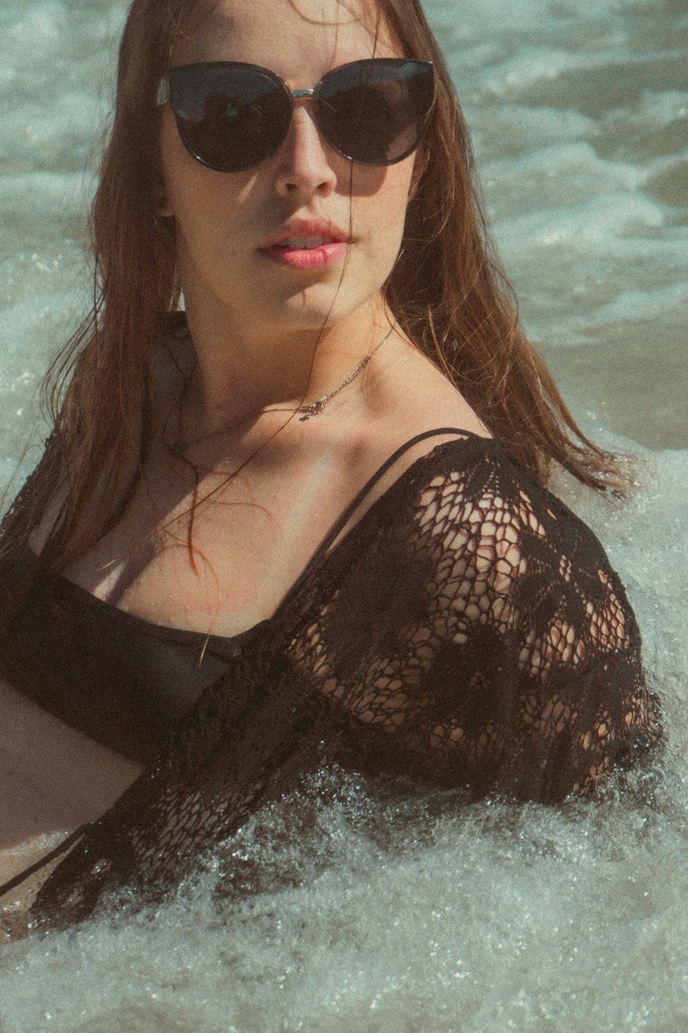 a woman laying on top of a wave in the ocean